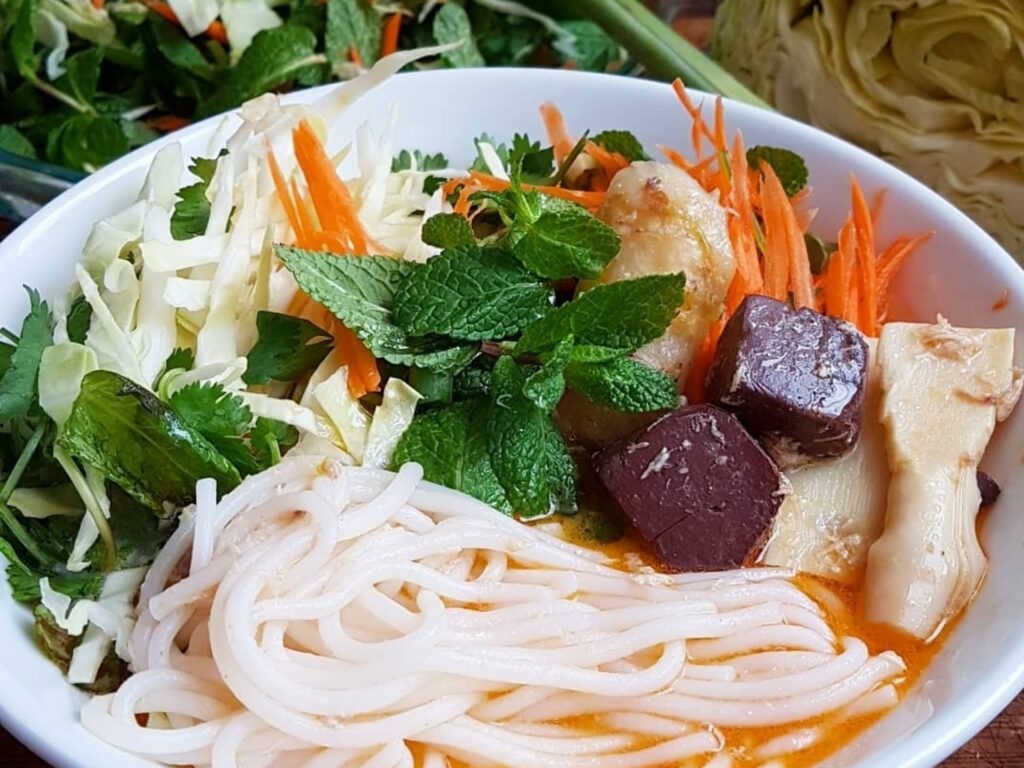 Khao poon - a noodle soup dish, fresh thinly sliced carrots and herbs